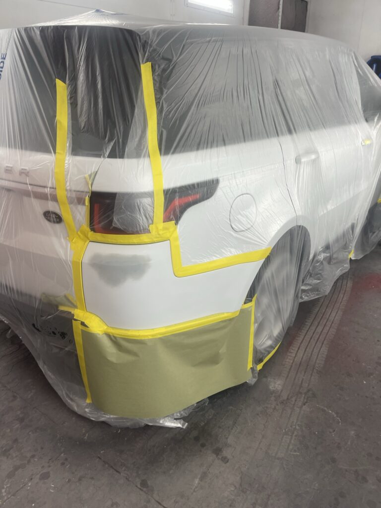Vehicle masked and prepped for professional paint application